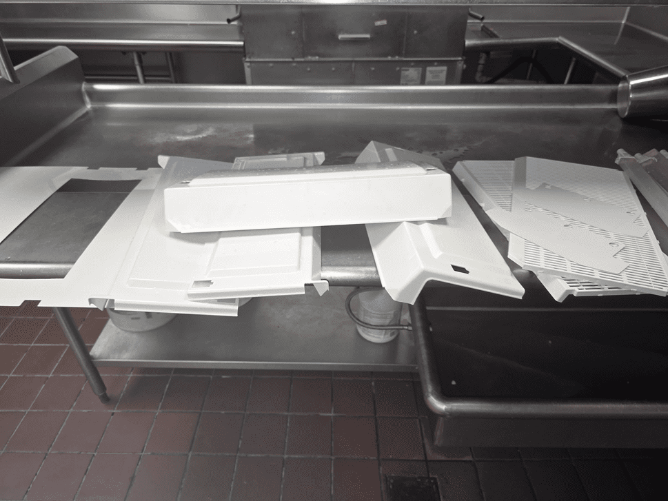 Ice machine panels and components disassembled for a thorough cleaning and inspection service