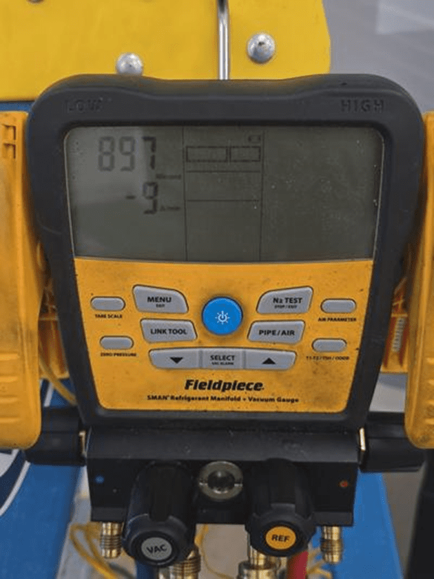 Fieldpiece SMAN manifold gauge confirming deep vacuum during system evacuation
