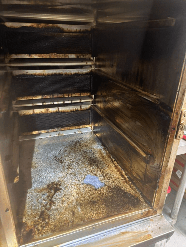 Oven interior before professional deep-clean — we restore equipment to working condition