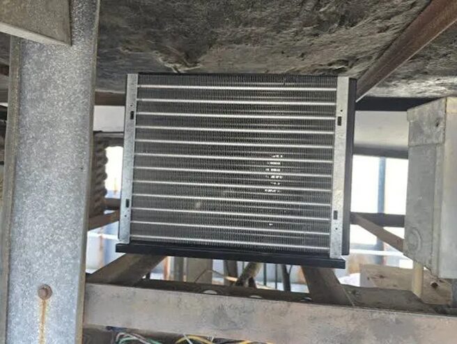 Evaporator coil with visible frost lines — a classic sign the cooler needs professional service.