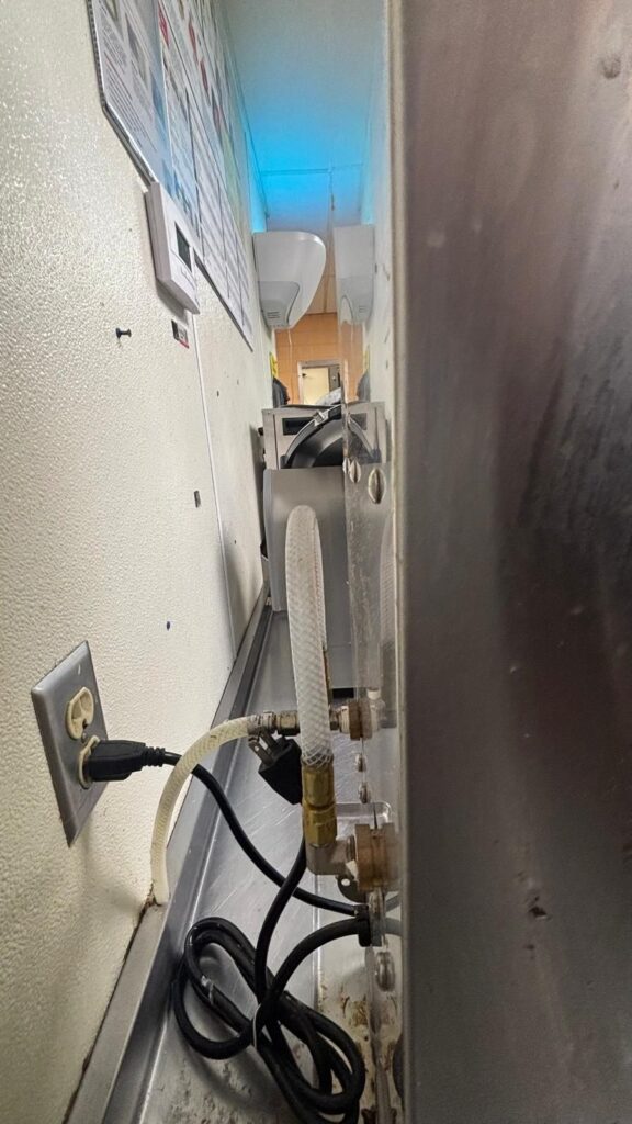 Final leak check on the supply line and fittings after the new valve was installed.