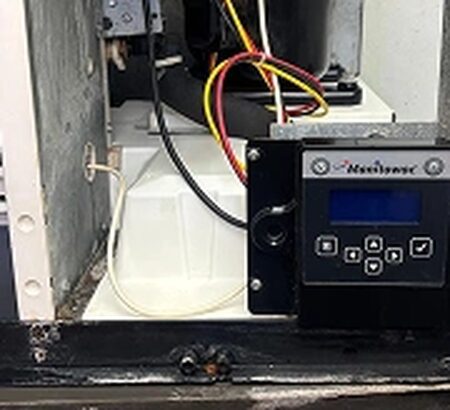 A control board and thermostat module inspected during a repair visit.
